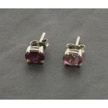 A pair of silver studs set with pink tourmaline