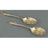 A pair of silver berry spoons, Sheffield 1894, Henry Wigfull, the repousse bowls with fruit and
