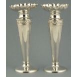 A pair of silver posy vases, London 1907, S W Smith & Co., of trumpet form with a foliate band, 21cm