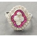 A Victorian style platinum and ruby dress ring, set with four central diamonds within a band of