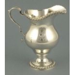 A helmet shape cream jug, London 1960, William Comyns & Sons Ltd, of bellied form raised on a