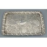 A silver rectangular dressing table tray, Birmingham 1906, H Matthews, with repousse decoration of