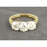 A three stone diamond dress ring, the bright-cut stones totaling 3ct claw set in an 18ct yellow gold