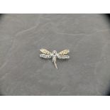 A silver dragonfly brooch / pendant set with amethyst, ruby eyes and wing tips marcasite and