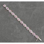 An 18ct white gold pink sapphire and diamond cluster line bracelet, pink sapphires 7.49ct,