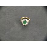 An 18ct yellow gold emerald and diamond cluster ring, emerald 1.60ct, total diamonds 1.50ct