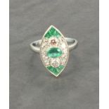 A platinum art deco style marquise shaped ring set with emeralds and diamonds, emeralds