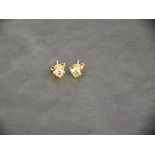 A pair of 18ct yellow gold four claw solitaire diamond studs, 0.51ct total