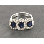 An 18ct white gold triple oval cut sapphire and diamond cluster ring, sapphires 1.88ct, diamonds 0.