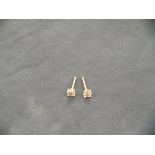 A pair of 18ct rose gold four claw solitaire diamonds studs, 0.38ct total