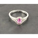 An 18ct white gold oval pink sapphire and diamond ring, pink sapphire 0.51ct, diamonds 0.17ct