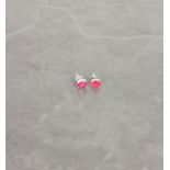 A pair of treated ruby studs, in silver