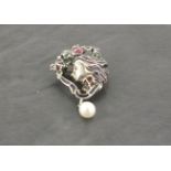 A silver brooch set with plique a jour and a suspended pearl