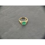 An 18ct yellow gold emerald and diamond ring, emerald approximately 1.73ct, 4 x baguette diamonds