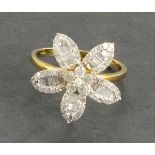 A flower shaped diamond dress ring, of Tomars Rea design. the setting totalling 1ct and set in a 9ct