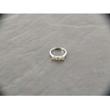An 18ct white gold three stone diamond ring, 1.54ct
