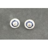 A pair of diamond and sapphire ear studs, target style, the central stones approx.. 0.90 ct, set