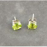 A pair of peridot ear studs the oval stones claw set in silver, 1.5gms