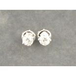 A pair of diamond ear studs, the brilliant cut stones claw set with 18ct white gold, 2gms