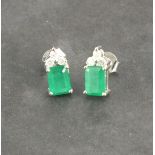 A pair of emerald and diamond set ear pendants, the rectangular cut stones with three cluster