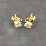 A pair of diamond ear studs, the brilliant cut stones approx. 0.62ct claw set in 18ct yellow gold,