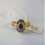 An oval sapphire and diamond cluster ring set in gold (stone missing)