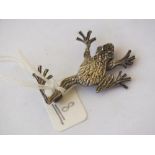 Silver frog brooch with green stone eyes