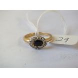 An oval sapphire and diamond cluster ring, set in 9ct. size N