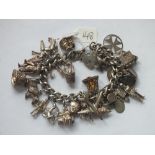 Heavy silver charm bracelet set with numerous interesting charms 122g inc