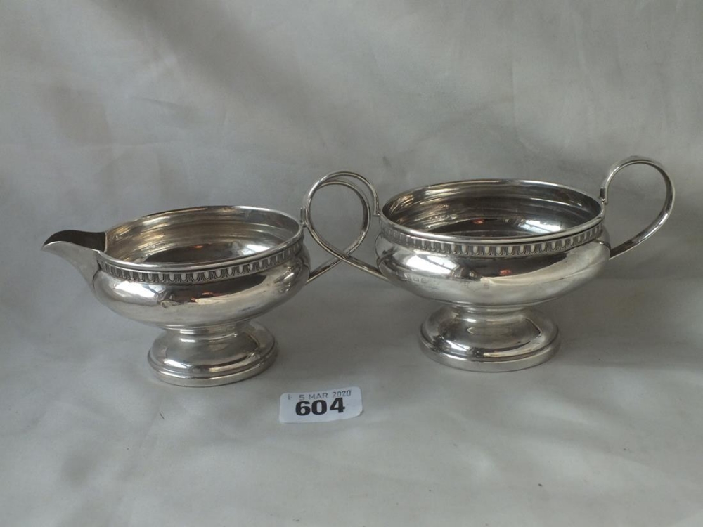 Pedestal cream jug, with egg and dart rim and a matching sugar basin, 6” over handles B’ham 1932