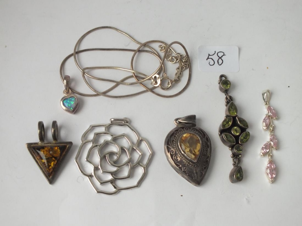 Six silver pendants and a chain