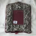 Large photo frame, heavily embossed with figures, 10” high, marked Sterling