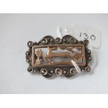 White & yellow metal rectangular brooch depicting a deer in flight