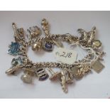 Silver charm bracelet set with numerous charms 59g