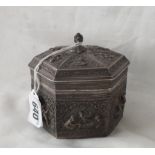 Eastern hexagonal box with lift off cover, embossed with panels of figures, 3” high 287g.
