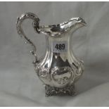 Victorian milk jug with embossed pear shaped body, raised on a collet foot, 5” over handle Lon