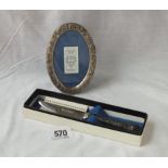 Oval embossed borded photo frame and a silver handled fruit knife