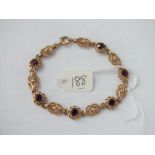 Fancy 9ct and garnet set bracelet 10.8g inc