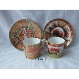 Two similar decorative coffee cans and saucers