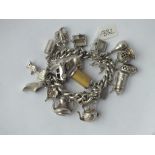 Heavy silver charm bracelet with numerous large charms 109g