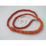 Carved red coral snake necklace