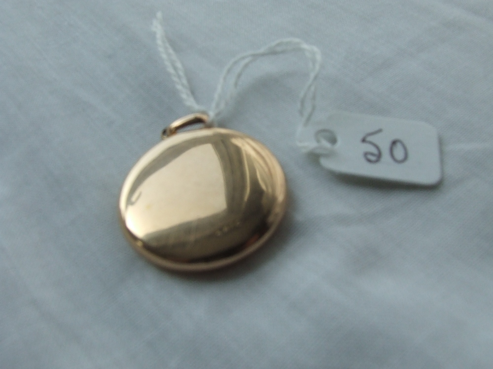 Circular gold Victorian locket marked 15ct – 8.3gms