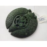 Large oriental carved green stone disc, 7” dia.