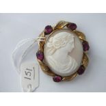 Oval gilt and red stone cameo brooch