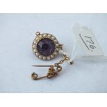 Circular amethyst and pearl bordered brooch set in gold