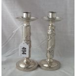 Pair of Chinese silver candle sticks with dragon decorated stem 5.5” high unmarked, 185g