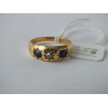 3 stone diamond and sapphire gypsy set ring in 18ct, size O, 5.4g