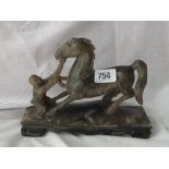 Eastern carving of a figure controlling horse 9” long