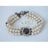 3 row pearl necklace with blue stone and silver clasp