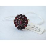 Garnet oval cluster ring set in 9ct, size Q, 4.9g